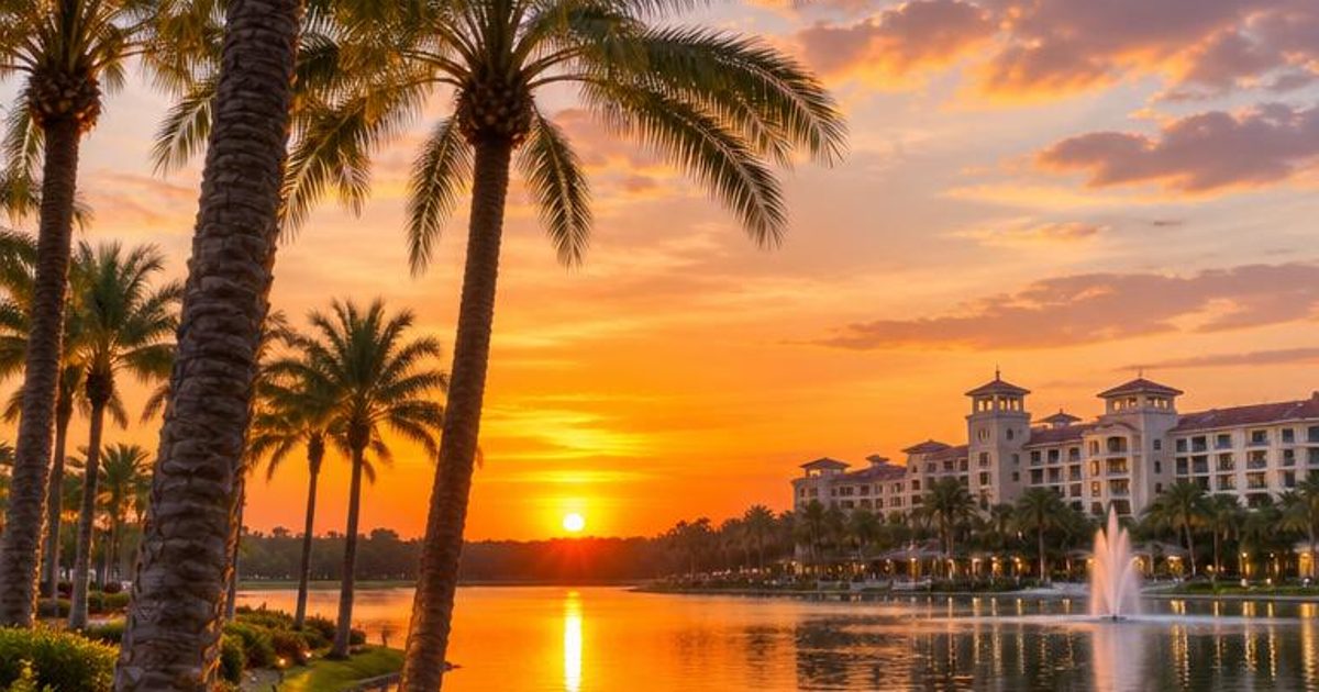 Palm-lined water with landscaped banks at sunset